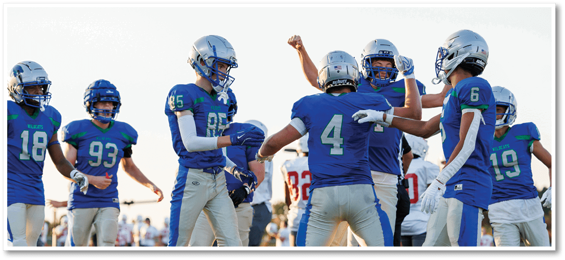 A group of football players on a field. Description generated by AI