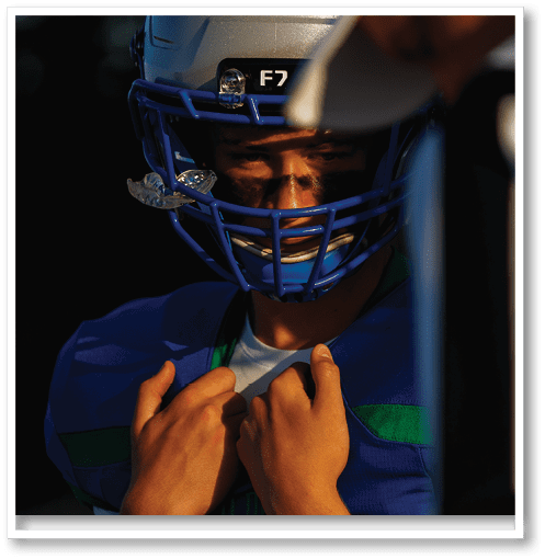 A football player wearing a black jersey with the number 6 on it. Description generated by AI