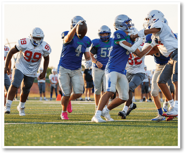 A football player is kicking a football on a field. Description generated by AI