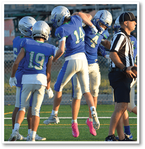 Two football players wearing black jerseys with the number 11 on them. Description generated by AI