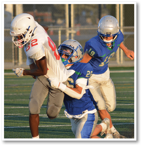 A football player wearing a black jersey with the number 6 on it. Description generated by AI