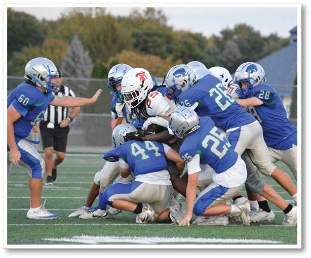 A group of football players wearing black jerseys with the number 3 on them. Description generated by AI