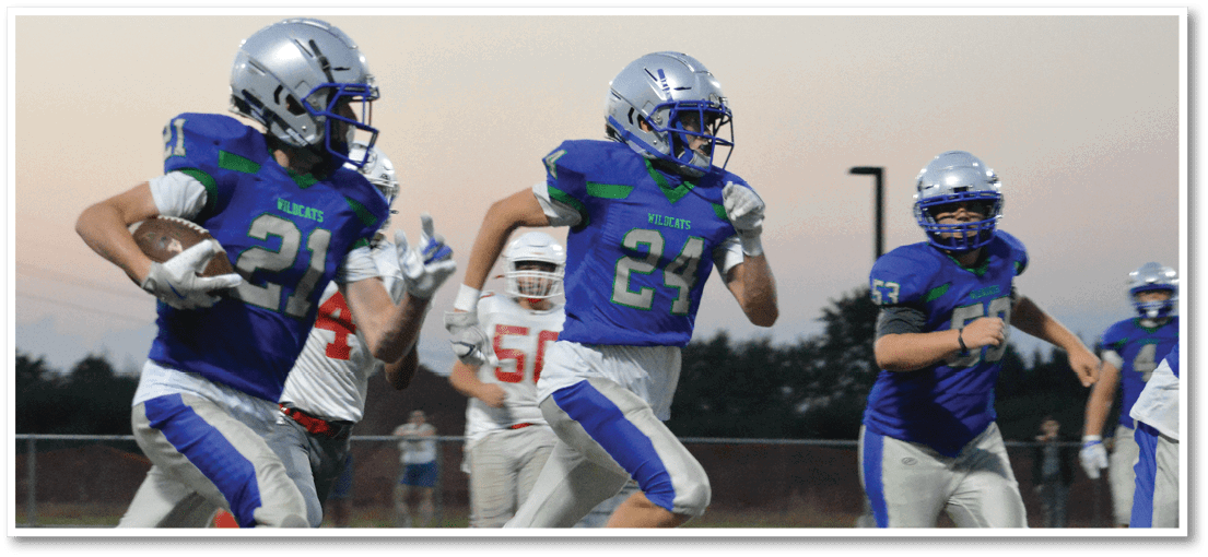 A group of football players on a field. Description generated by AI