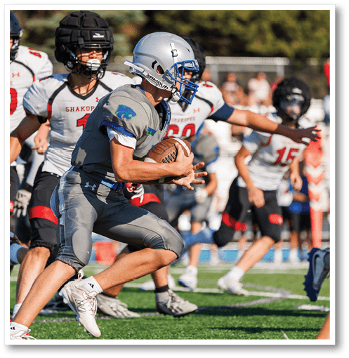 Two football players wearing black jerseys with the number 11 on them. Description generated by AI