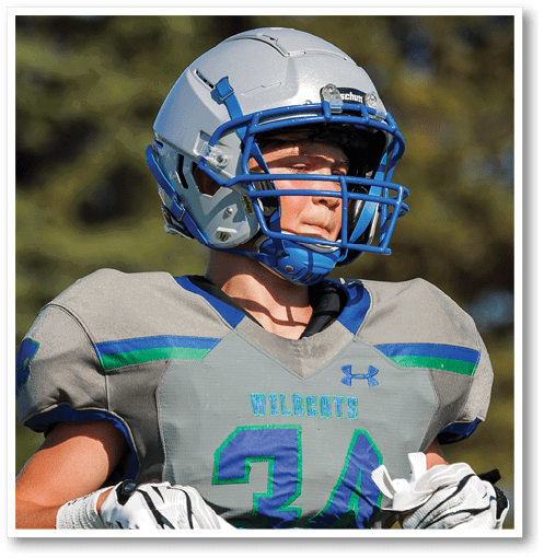 A football player wearing a black jersey with the number 6 on it. Description generated by AI