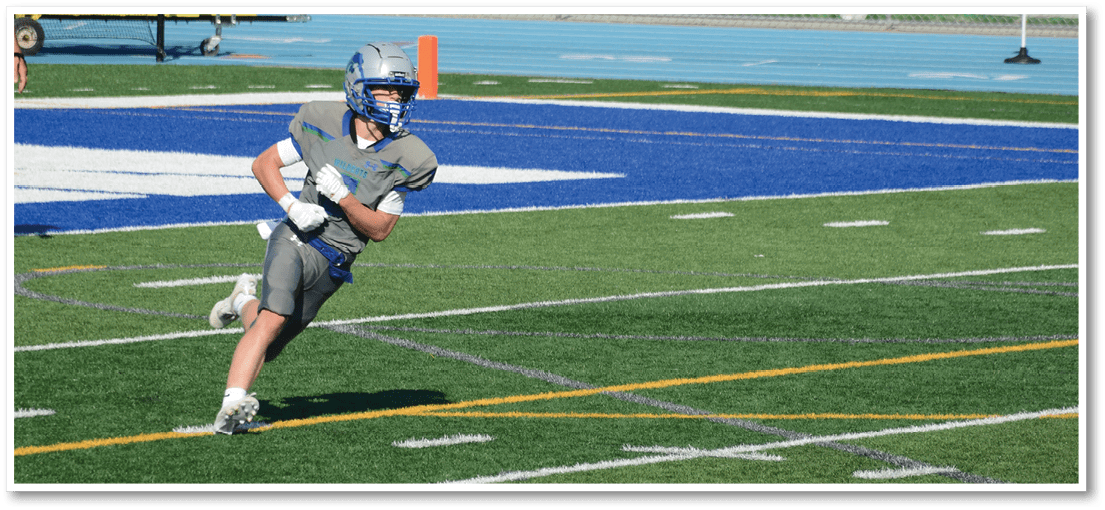 A football player running on the field. Description generated by AI