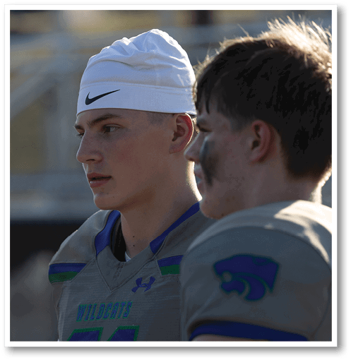 A football player wearing a black jersey with the number 6 on it. Description generated by AI