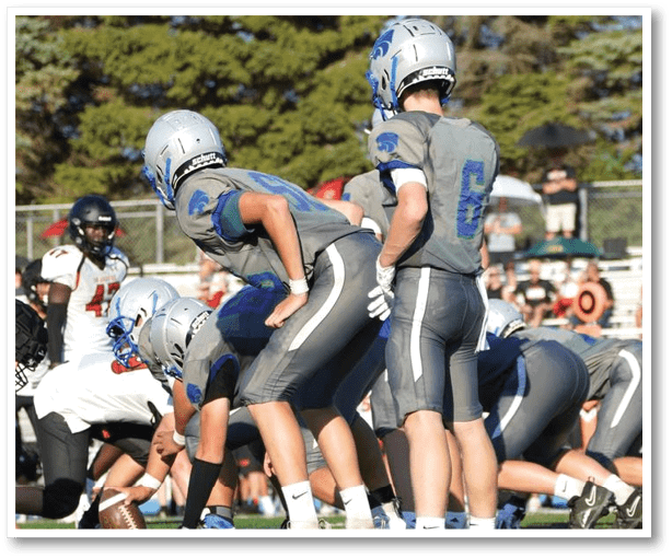 A football player is kicking a football on a field. Description generated by AI