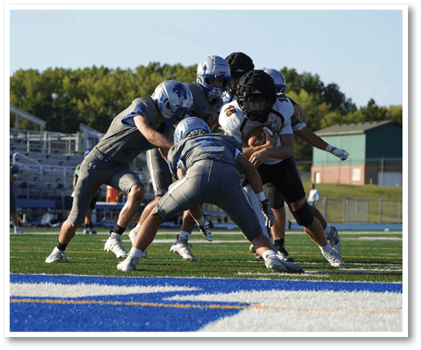 A group of football players wearing black jerseys with the number 3 on them. Description generated by AI