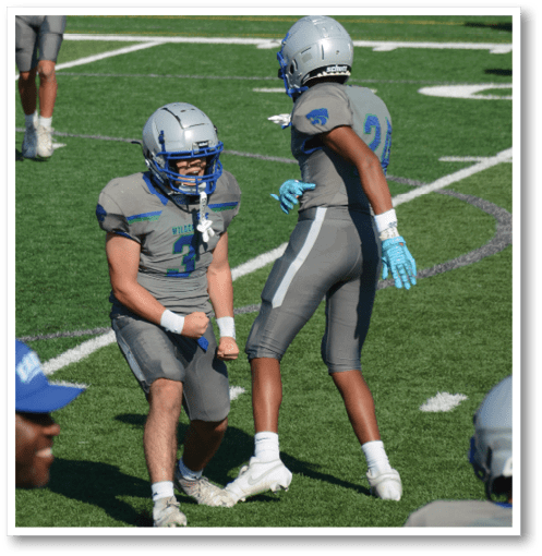 Two football players wearing black jerseys with the number 11 on them. Description generated by AI