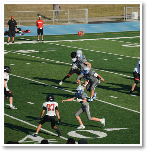 Two football players wearing black jerseys with the number 11 on them. Description generated by AI