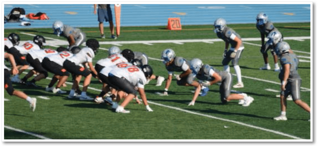 A group of football players on a field. Description generated by AI
