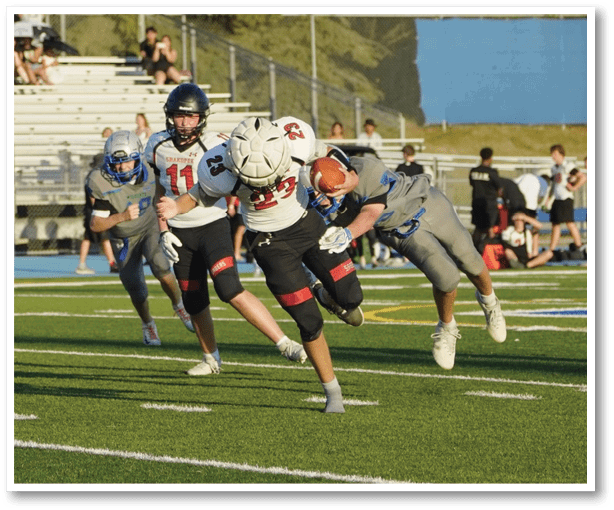 A group of football players wearing black jerseys with the number 3 on them. Description generated by AI