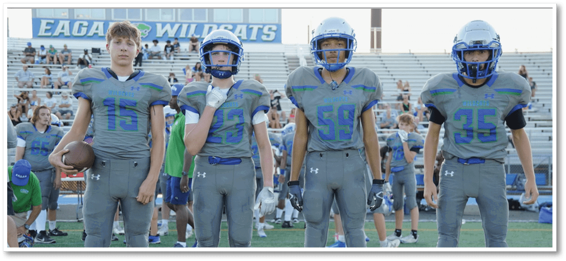 A group of football players on a field. Description generated by AI