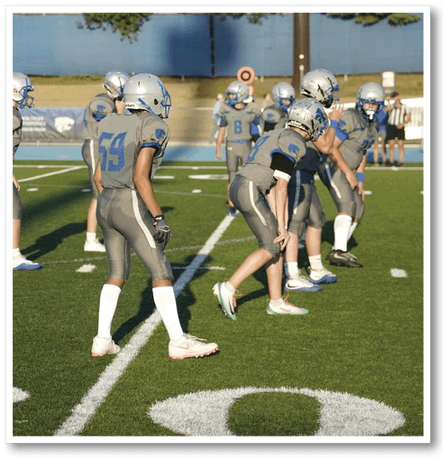 A football player wearing a black jersey with the number 6 on it. Description generated by AI
