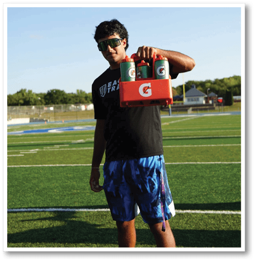 A football player wearing a black jersey with the number 6 on it. Description generated by AI