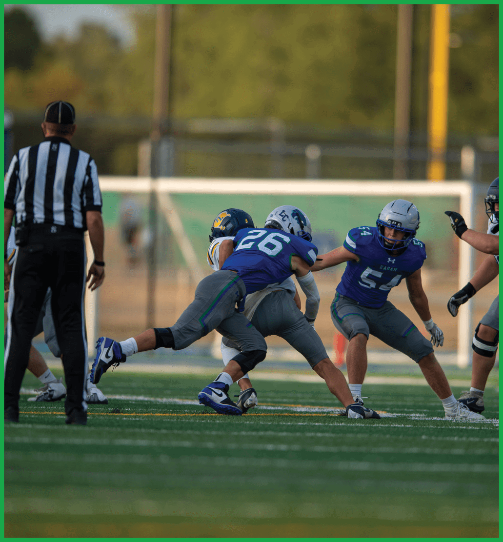A football player running with a football. Description generated by AI