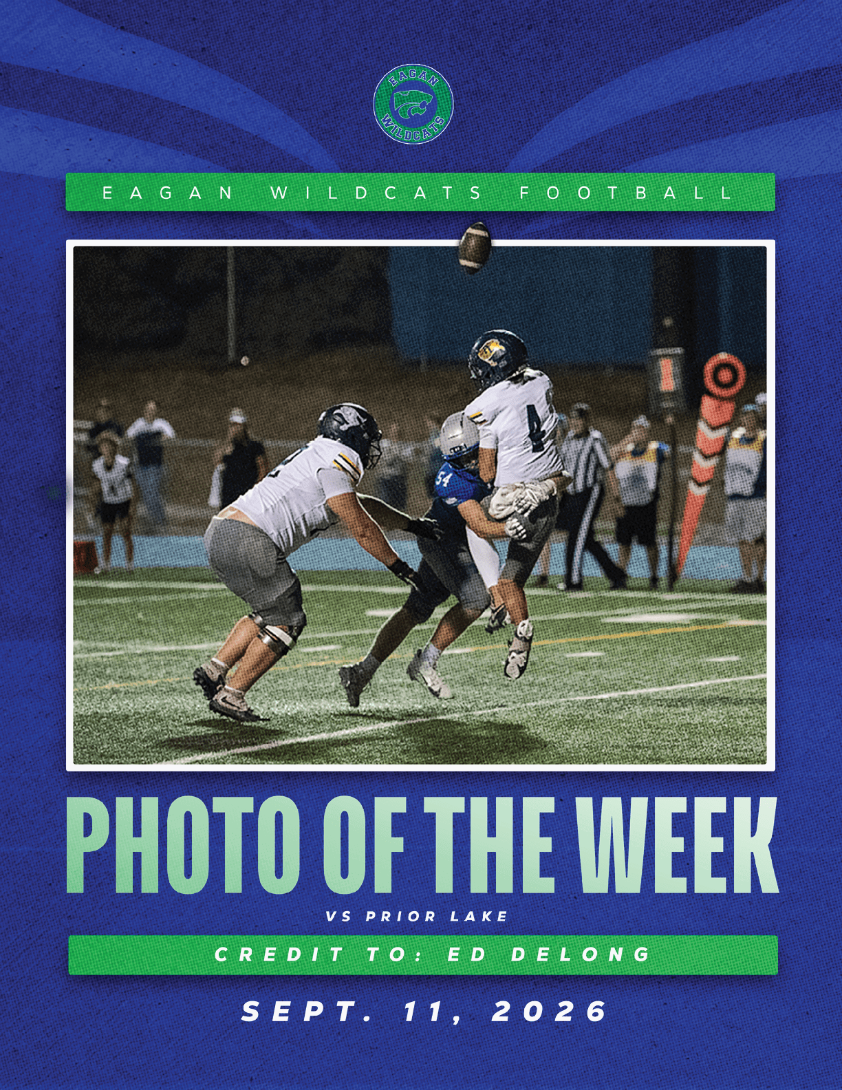 A football player in a green jersey is jumping in the air. Description generated by AI