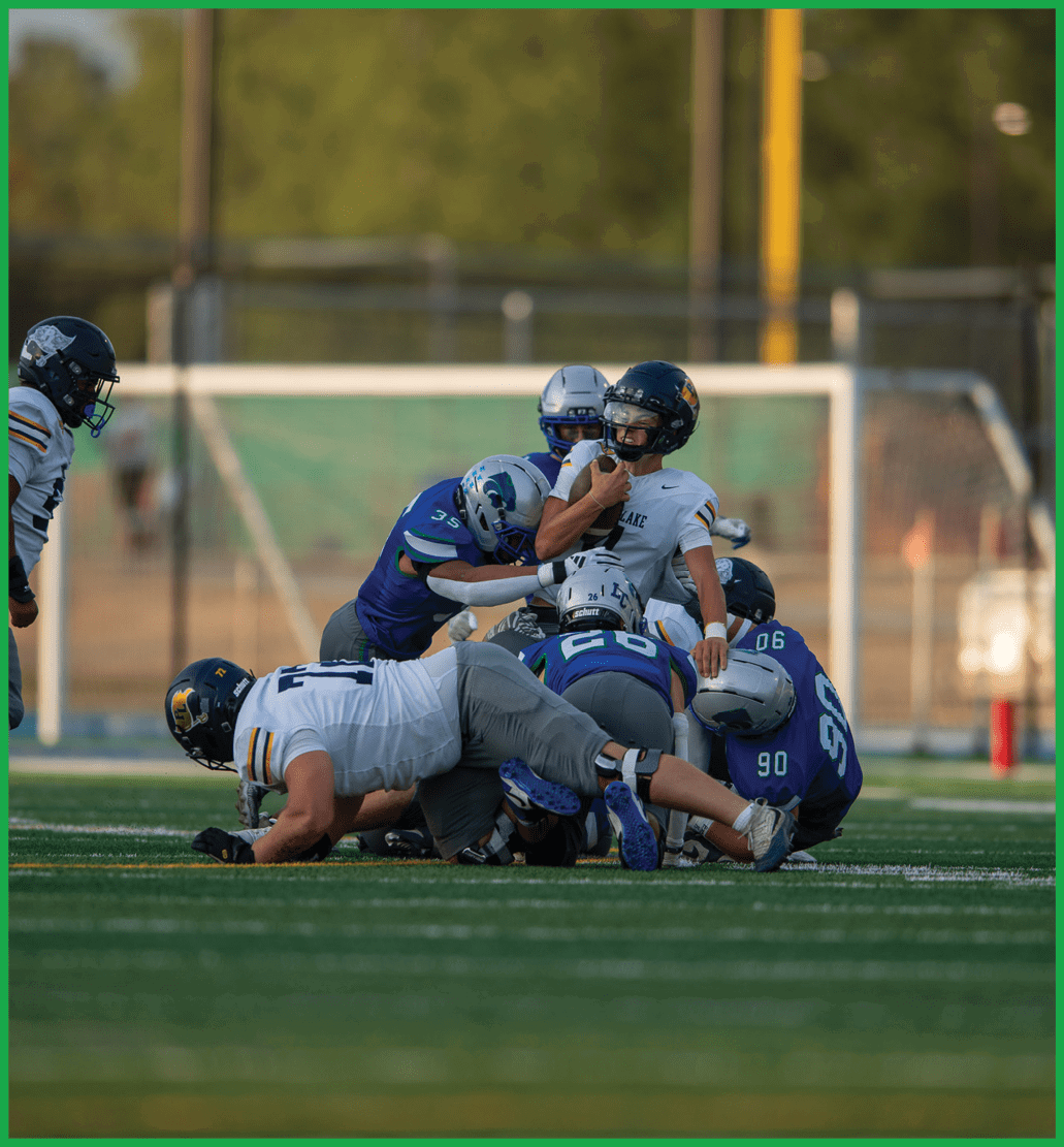 A football player running on the field. Description generated by AI