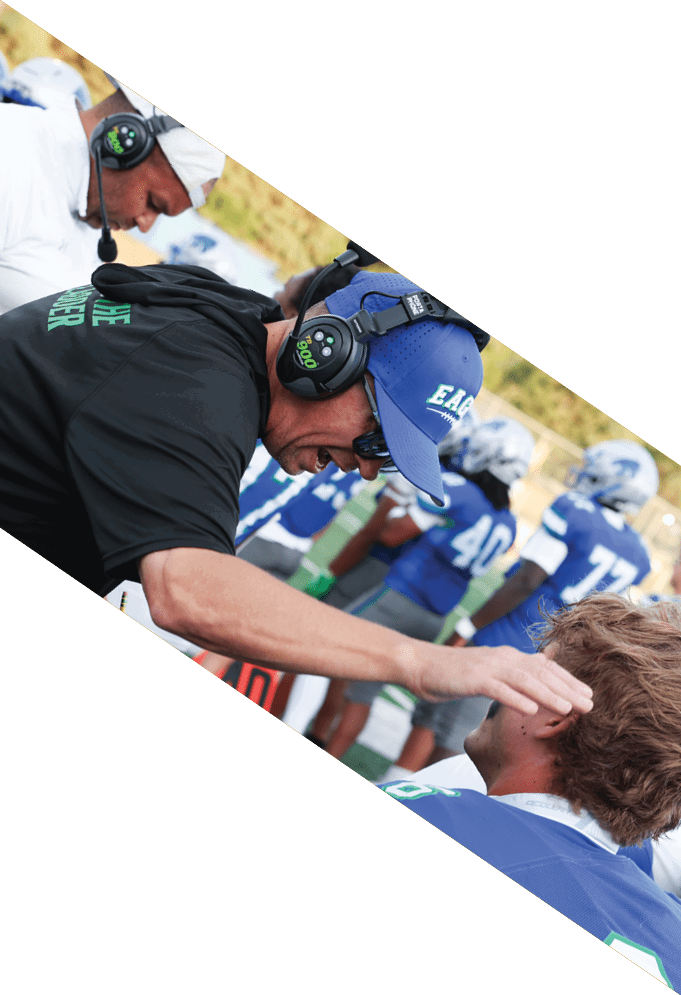Three football players wearing green uniforms and black helmets pose for a photo. AI generated content