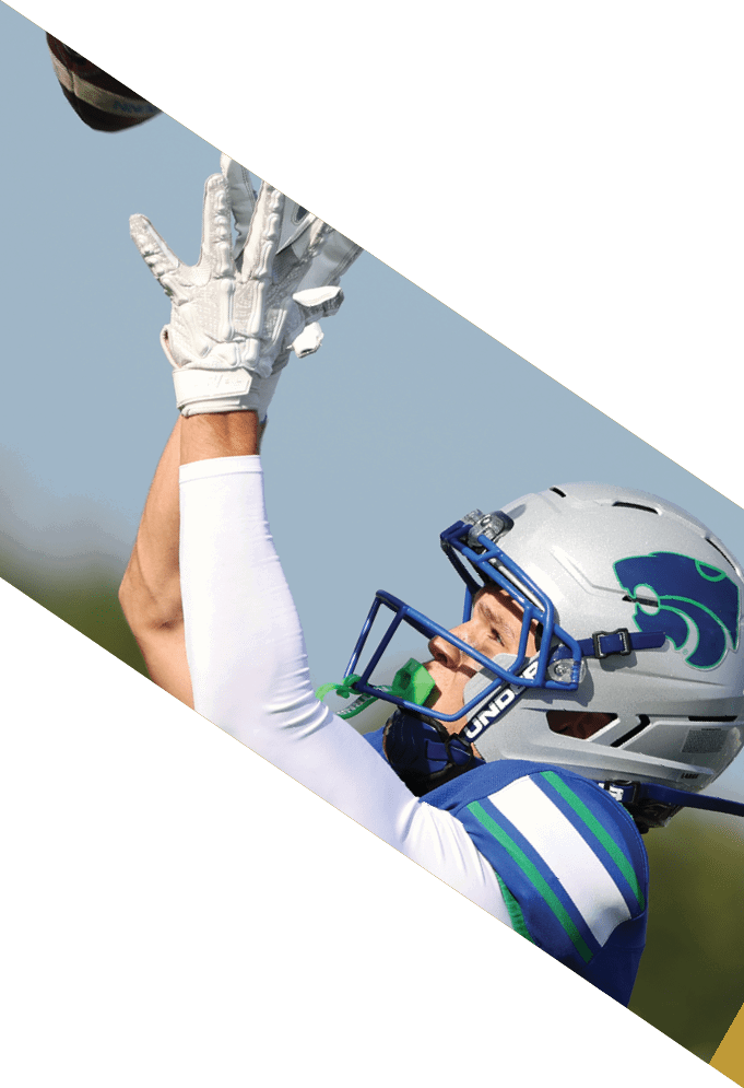 Four football players pose for a picture on the field. AI generated content