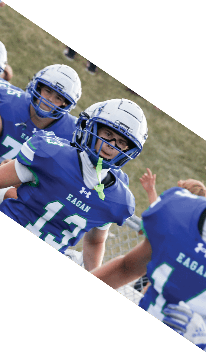 A group of people wearing black jerseys are huddled together on a field. AI generated content