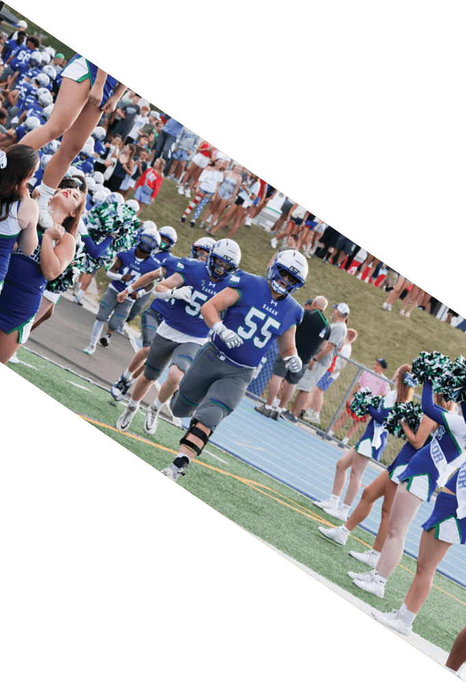 Four football players pose for a picture on the field. AI generated content