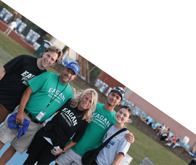 A group of football players kneeling on the field, some with their hands on their heads. AI generated content