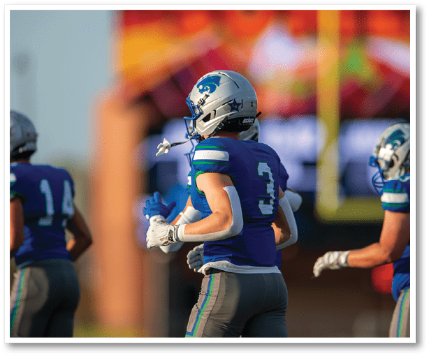 A group of football players wearing black jerseys with the number 3 on them. Description generated by AI