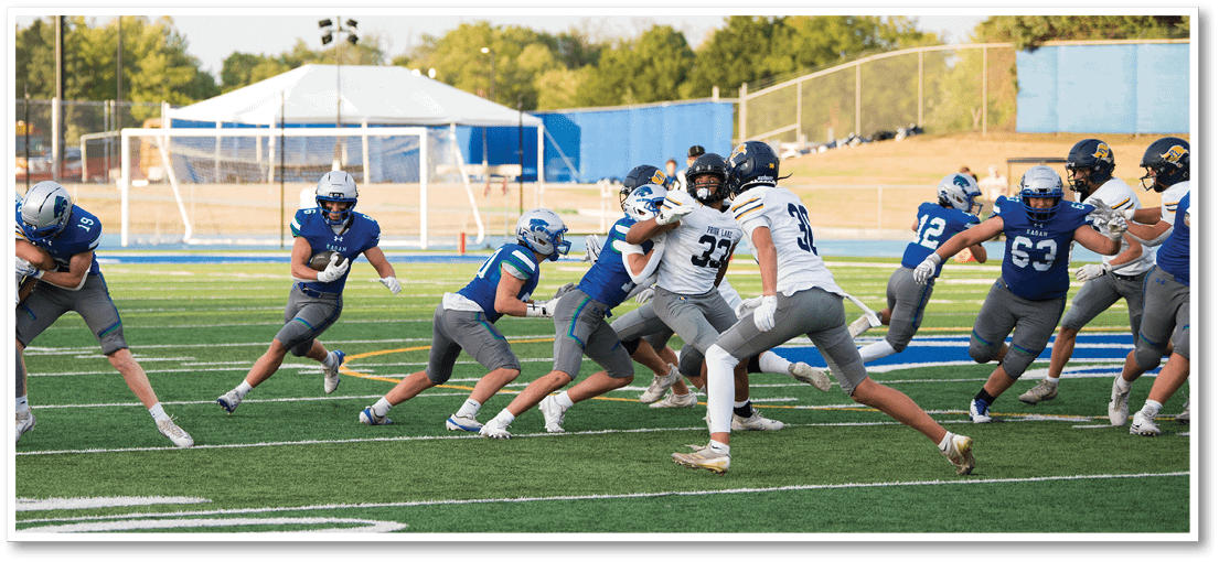 A group of football players on a field. Description generated by AI