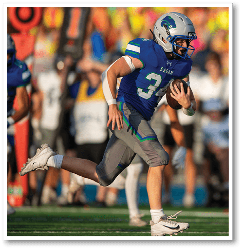 A football player wearing a black jersey with the number 6 on it. Description generated by AI