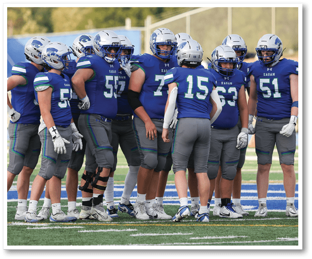 A group of football players wearing black jerseys with the number 3 on them. Description generated by AI