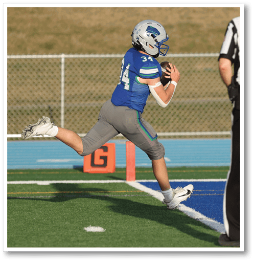 Two football players wearing black jerseys with the number 11 on them. Description generated by AI