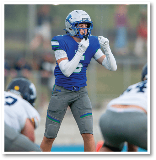 A football player wearing a black jersey with the number 6 on it. Description generated by AI