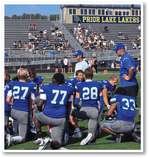 Two football players wearing black jerseys with the number 11 on them. Description generated by AI