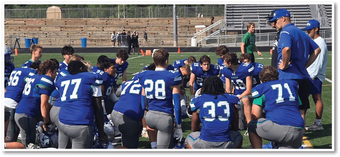 A group of football players on a field. Description generated by AI