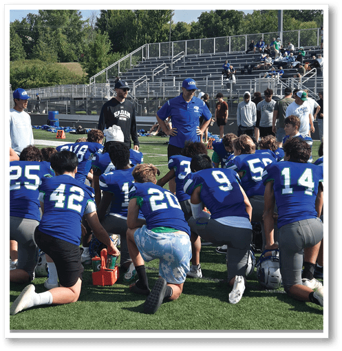 A group of men wearing black and white jerseys. Description generated by AI