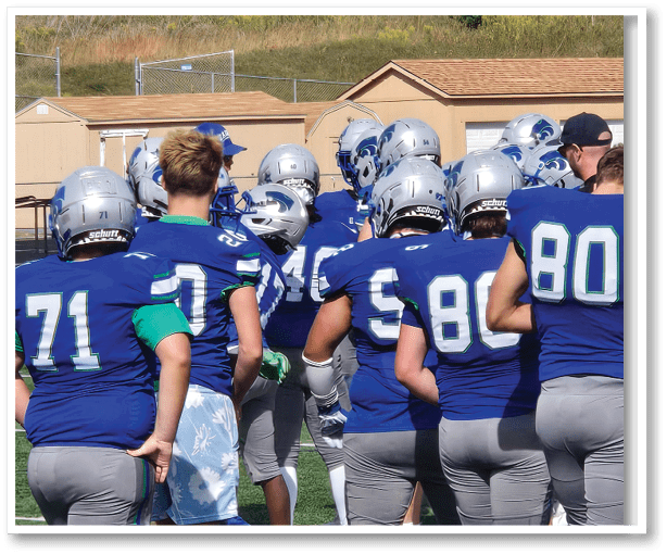 A group of football players wearing black jerseys with the number 3 on them. Description generated by AI
