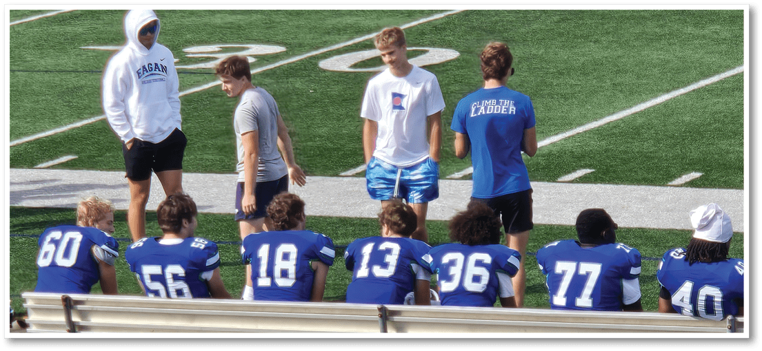 A group of football players on a field. Description generated by AI