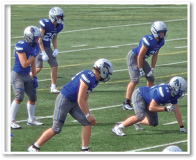 A group of men wearing black and white jerseys. Description generated by AI