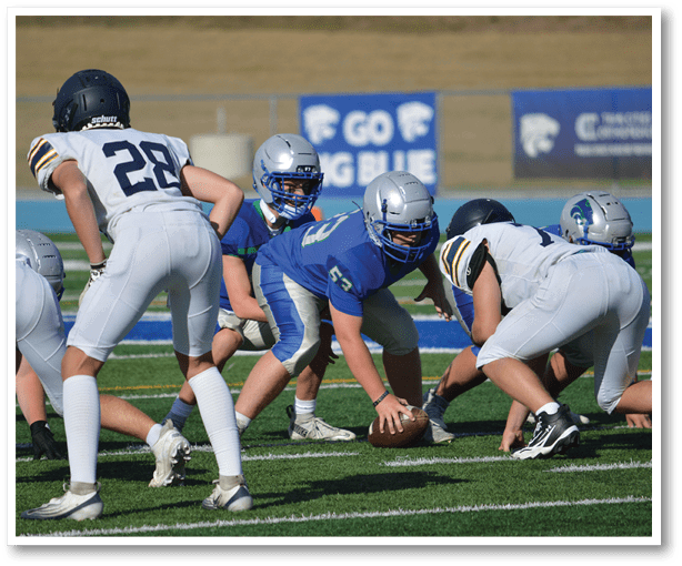 A group of football players wearing black jerseys with the number 3 on them. Description generated by AI