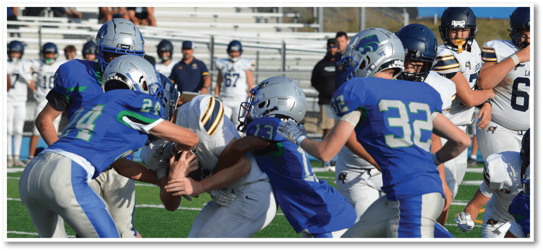 A group of football players on a field. Description generated by AI