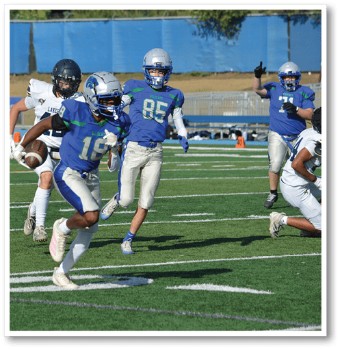 A football player wearing a black jersey with the number 6 on it. Description generated by AI