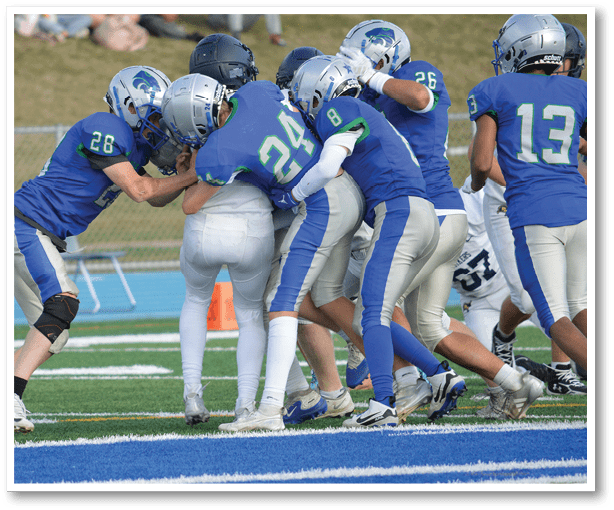 A football player is kicking a football on a field. Description generated by AI
