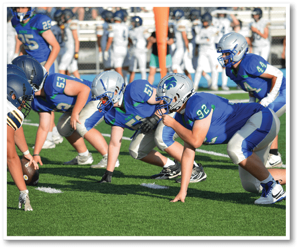 A group of football players wearing black jerseys with the number 3 on them. Description generated by AI