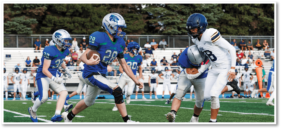 A group of football players on a field. Description generated by AI