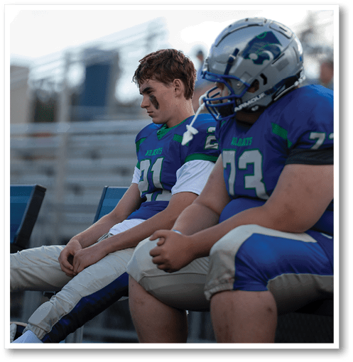 A group of men wearing black and white jerseys. Description generated by AI