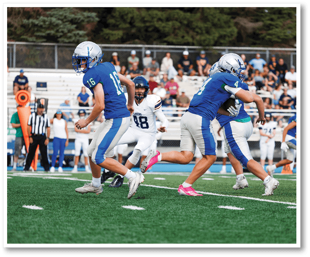 A group of football players wearing black jerseys with the number 3 on them. Description generated by AI