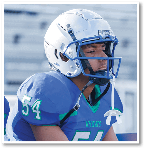 A football player wearing a black jersey with the number 6 on it. Description generated by AI