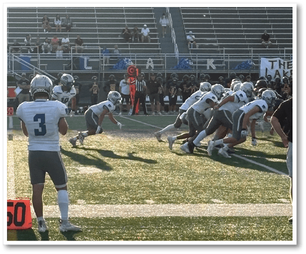 A group of football players wearing black jerseys with the number 3 on them. Description generated by AI